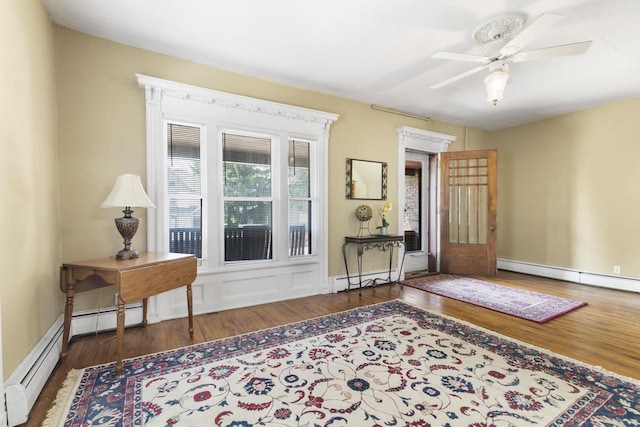 interior space with a baseboard radiator, dark hardwood / wood-style floors, and ceiling fan