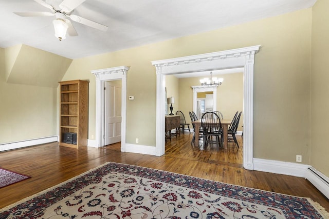 dining room with dark hardwood / wood-style flooring, a baseboard heating unit, and ceiling fan with notable chandelier