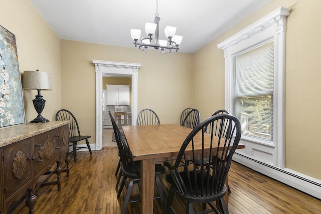 dining space with a baseboard radiator, a notable chandelier, and dark hardwood / wood-style flooring