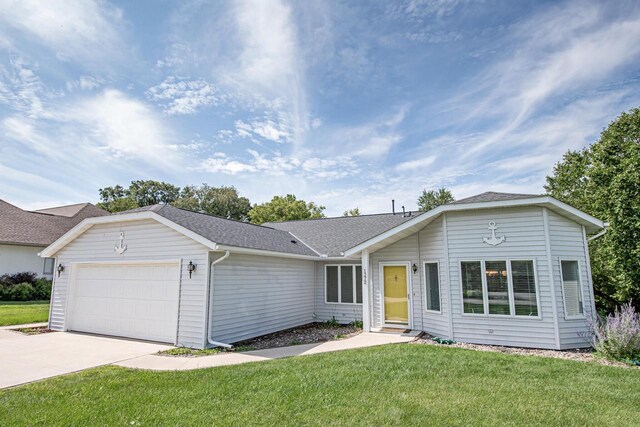 ranch-style home with a garage and a front yard