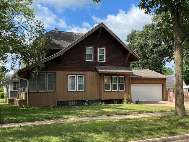 view of home's exterior with a garage and a yard