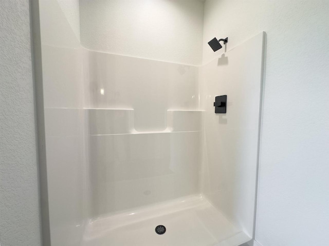 716 Kelsey Rd, Beloit, WI 53511 - bathroom with a stall shower and a textured wall