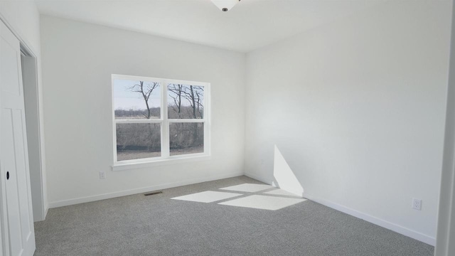 3272 S Bartells Dr, Beloit, WI 53511 - spare room with baseboards, carpet flooring, and visible vents