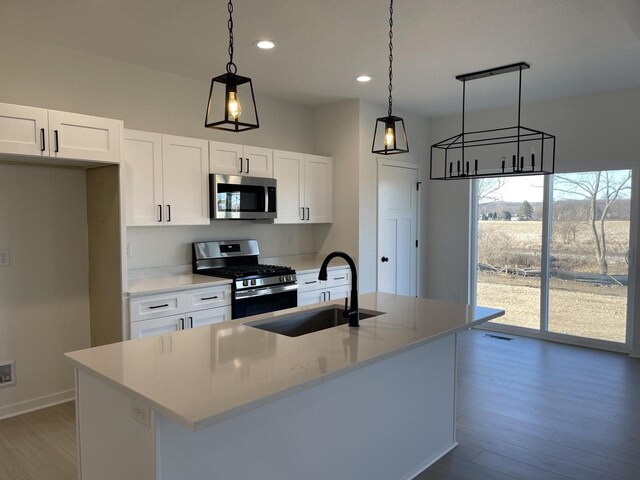 3272 S Bartells Dr, Beloit, WI 53511 - kitchen featuring white cabinetry, a sink, a center island with sink, and appliances with stainless steel finishes