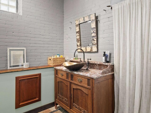 834 N Water St, Sheboygan, WI 53081 - interior space featuring brick wall and vanity