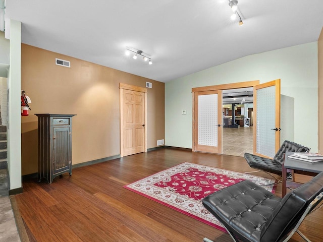 834 N Water St, Sheboygan, WI 53081 - living room with hardwood / wood-style floors, rail lighting, vaulted ceiling, and french doors