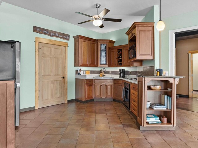 834 N Water St, Sheboygan, WI 53081 - kitchen with sink, kitchen peninsula, pendant lighting, ceiling fan, and black appliances