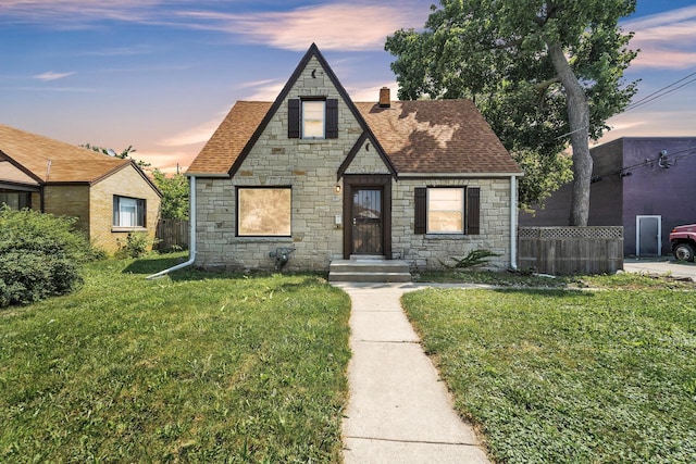 tudor-style house with a yard