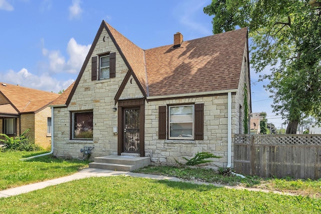 english style home with a front yard