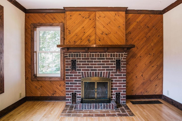 room details featuring hardwood / wood-style floors, crown molding, and wood walls