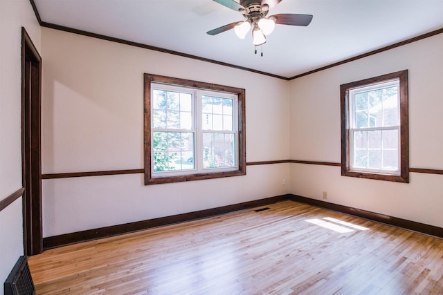 spare room with crown molding, light hardwood / wood-style flooring, and ceiling fan