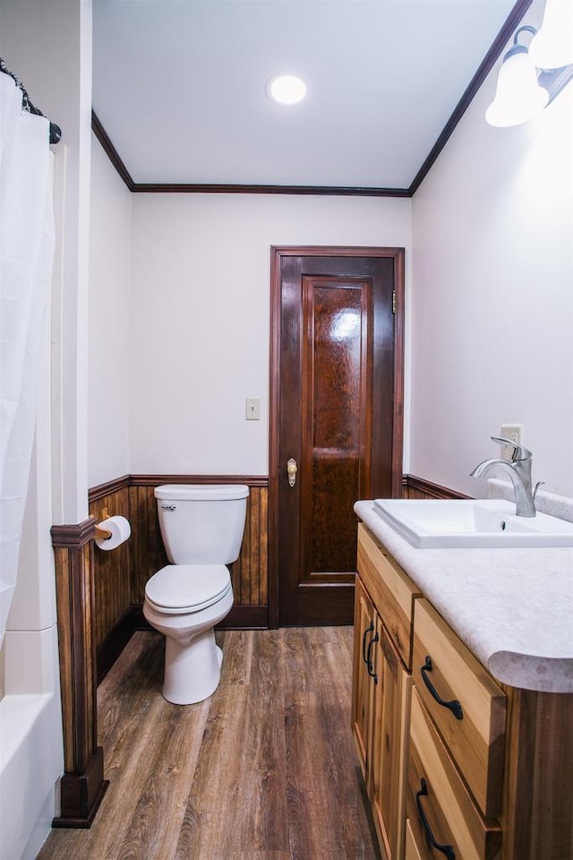 full bathroom featuring crown molding, vanity, toilet, and hardwood / wood-style floors