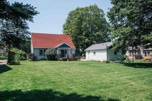 rear view of property featuring a lawn