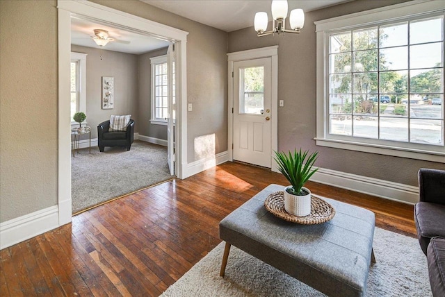 foyer with an inviting chandelier and dark hardwood / wood-style floors