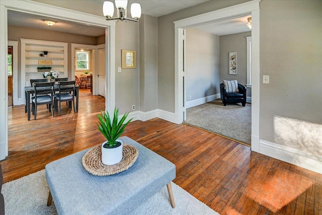 interior space featuring hardwood / wood-style flooring and a chandelier