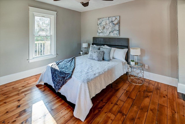 bedroom with ceiling fan and hardwood / wood-style flooring