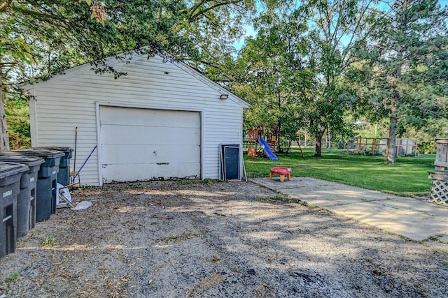 garage featuring wooden walls and a yard