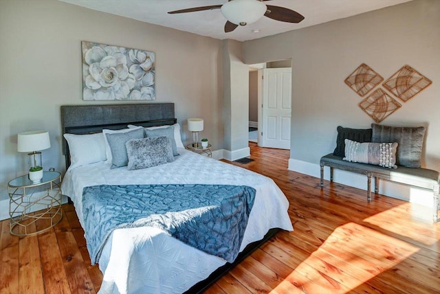 bedroom with ceiling fan and hardwood / wood-style flooring