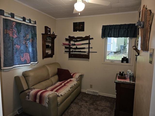 living area with dark colored carpet and ceiling fan