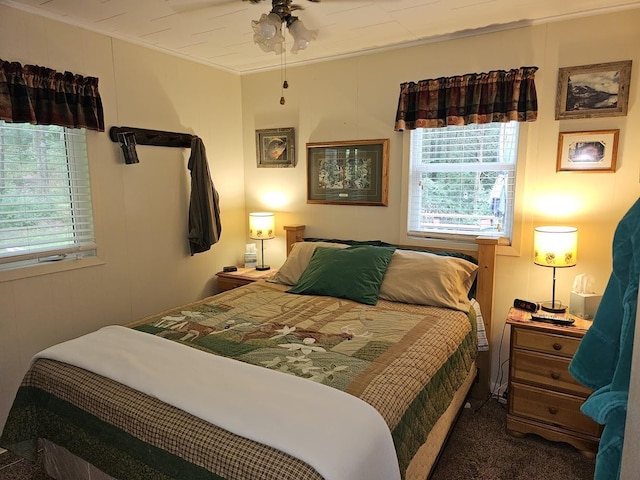 carpeted bedroom featuring crown molding and ceiling fan