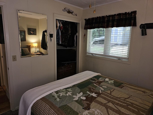 bedroom featuring ornamental molding and a closet