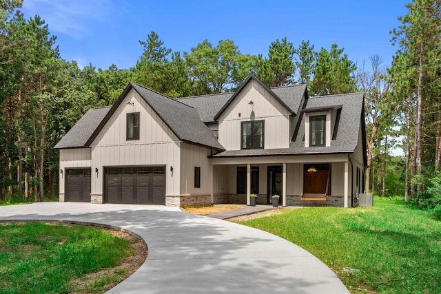 modern farmhouse style home featuring central AC, a porch, a garage, and a front lawn