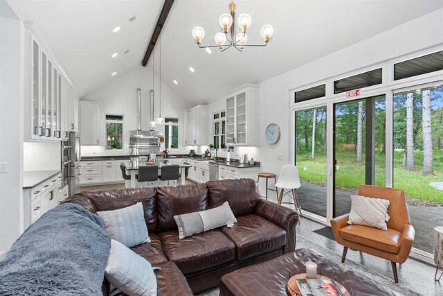 living room with beam ceiling, high vaulted ceiling, and a notable chandelier