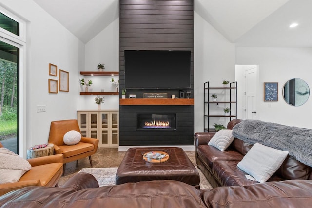 living room featuring vaulted ceiling and a large fireplace