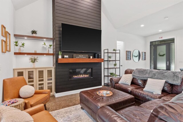 living room featuring high vaulted ceiling and a fireplace