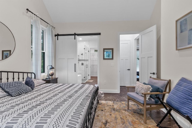 bedroom with vaulted ceiling, ensuite bathroom, and a barn door