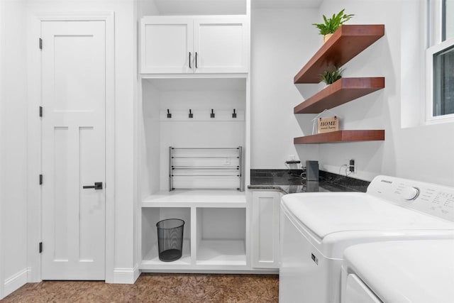 laundry room featuring cabinets and washing machine and clothes dryer