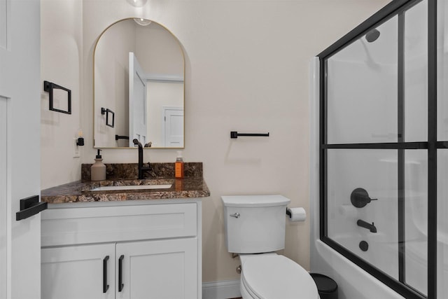 full bathroom featuring toilet, vanity, and shower / bath combination with glass door