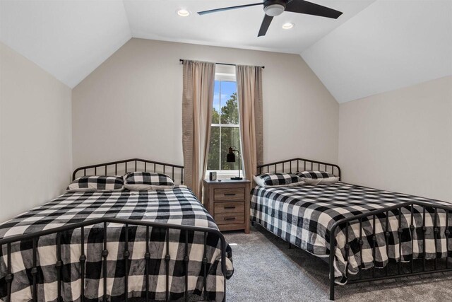 carpeted bedroom featuring lofted ceiling and ceiling fan