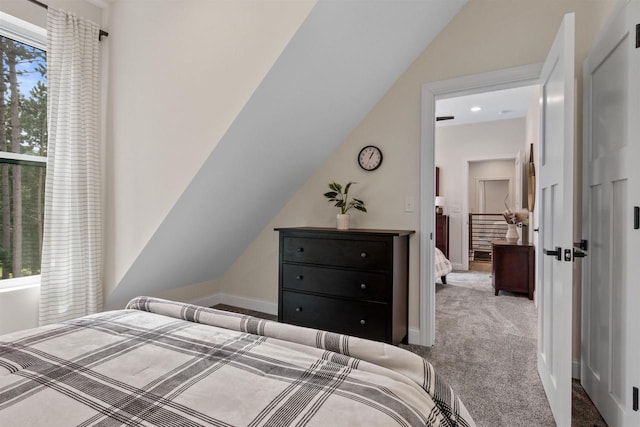 bedroom featuring vaulted ceiling and light carpet