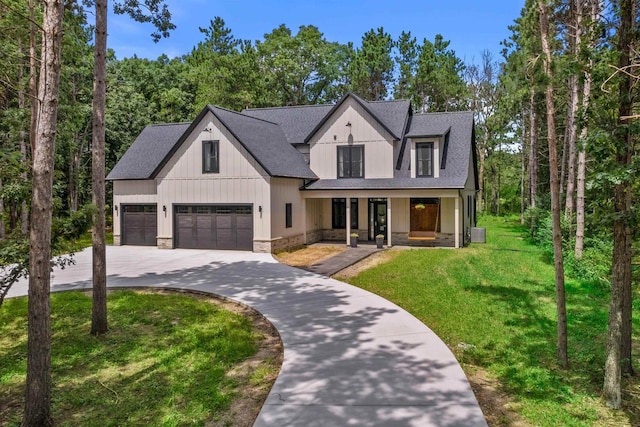 modern farmhouse style home featuring a porch and a front lawn