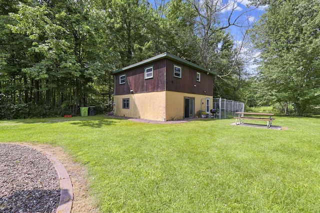 view of side of home featuring a lawn