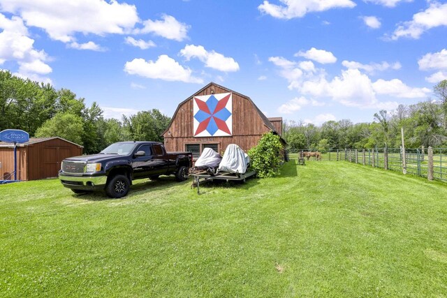 view of outbuilding featuring a lawn