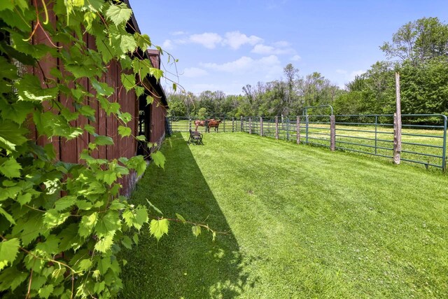 view of yard with an outbuilding and a rural view