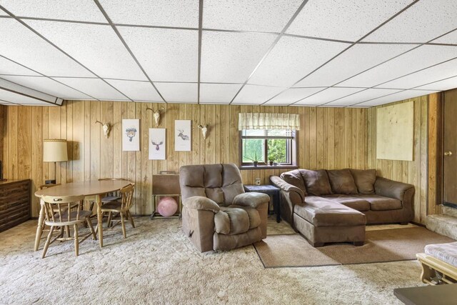 carpeted living room with a drop ceiling