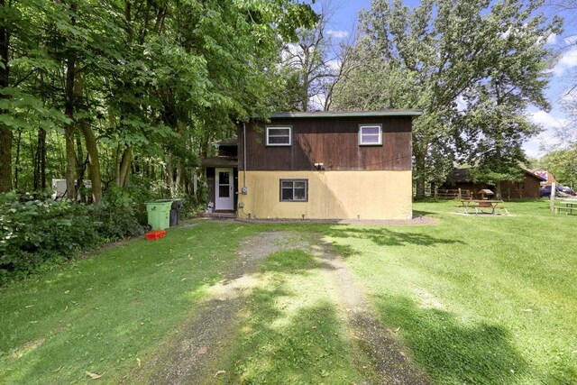 rear view of property with a lawn