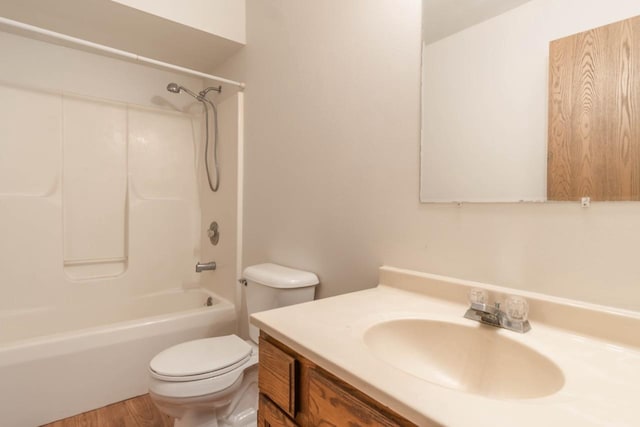 full bathroom featuring hardwood / wood-style floors, vanity, bathing tub / shower combination, and toilet