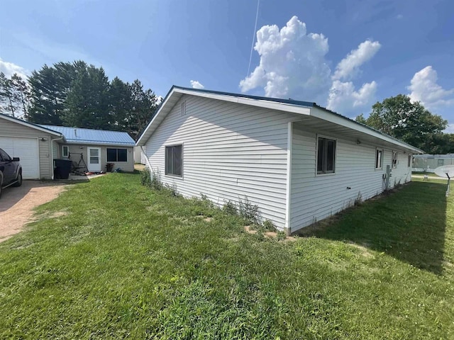 view of side of home with a yard