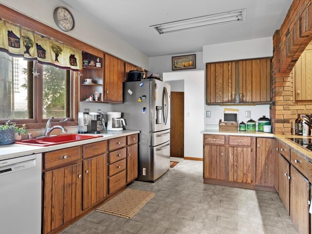 W7031 Hickory Ln, Elkhart Lake, WI 53020 - kitchen featuring brown cabinetry, dishwasher, light countertops, open shelves, and a sink