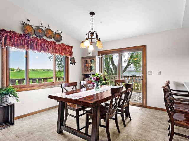 W7031 Hickory Ln, Elkhart Lake, WI 53020 - dining area featuring light floors, baseboards, and a notable chandelier