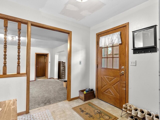 W7031 Hickory Ln, Elkhart Lake, WI 53020 - entryway featuring arched walkways, light carpet, and baseboards