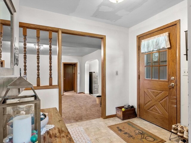 W7031 Hickory Ln, Elkhart Lake, WI 53020 - entryway with arched walkways, light carpet, and baseboards