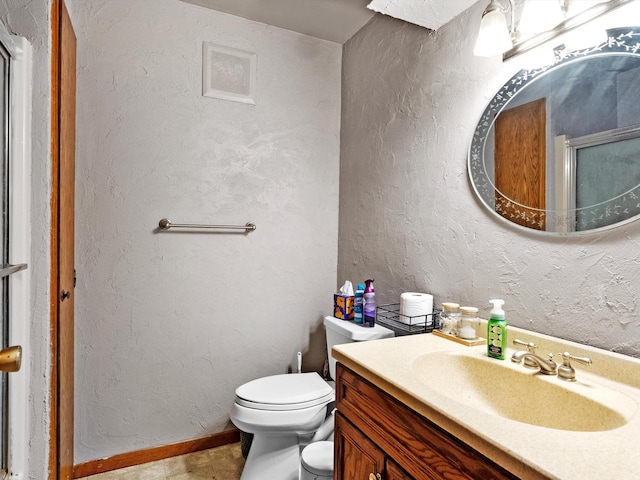 W7031 Hickory Ln, Elkhart Lake, WI 53020 - bathroom with a textured wall, toilet, a shower with shower door, vanity, and baseboards