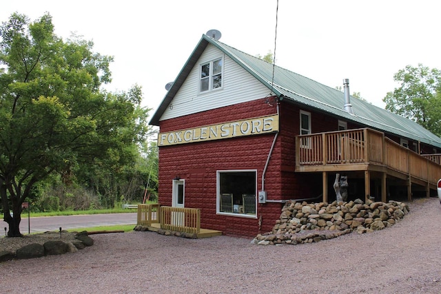 view of side of property with a wooden deck