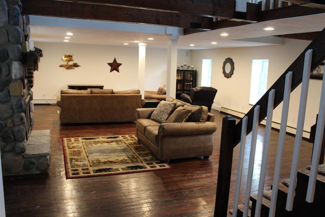 living room with a baseboard radiator, dark wood-type flooring, and beamed ceiling