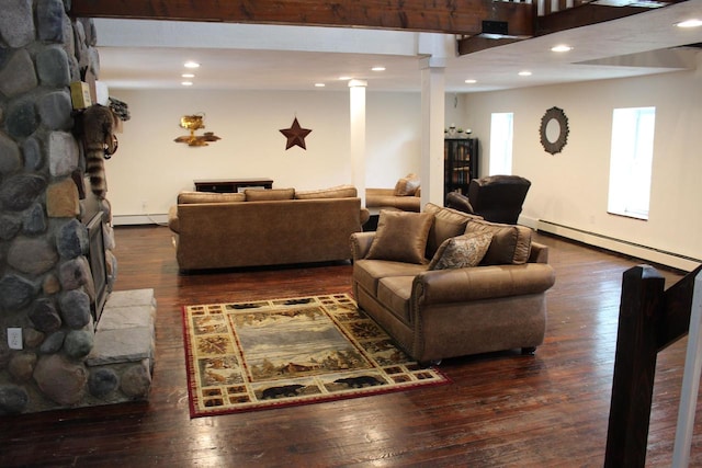 living room with dark hardwood / wood-style floors and a baseboard heating unit